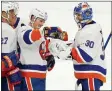  ?? JEFFREY T. BARNES - THE ASSOCIATED PRESS ?? FILE - In this Feb. 16, 2021, file photo, New York Islanders forward Casey Cizikas (53) gives goalie
Ilya Sorokin (30) the game puck to celebrate a 3-0victory following the third period of an NHL hockey game against the Buffalo Sabres in Buffalo, N.Y.