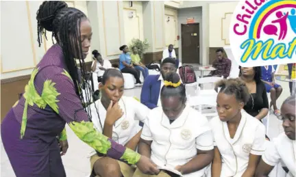  ?? (Photos: Garfield Robinson) ?? (From left) CEO of Sagicor Bank Jamaica Chorvelle Johnson Cunningham engages in a reading session with Charlie Smith High School students Kadian Williams, Onielia Vassell, Kimona Minto and Tisha Stewart on May 9, 2023.
