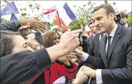  ?? ALAIN JOCARD / THE NEW YORK TIMES ?? French President Emmanuel Macron greets the crowd after a ceremony in Paris following his inaugurati­on on Sunday.