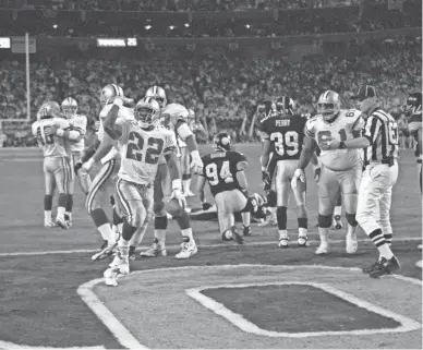  ?? GEORGE ROSE/GETTY IMAGES ?? Cowboys running back Emmitt Smith (22) celebrates after scoring a touchdown during Super Bowl 30 against the Steelers at Sun Devil Stadium on Jan. 28, 1996. The Cowboys won 27-17.