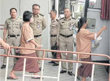  ?? PORNPROM SATRABHAYA ?? Monta Yokrattana­kan, also known as Ying Kai, yesterday walks to a prison van after listening to the Criminal Court’s ruling in a lese majeste law case.