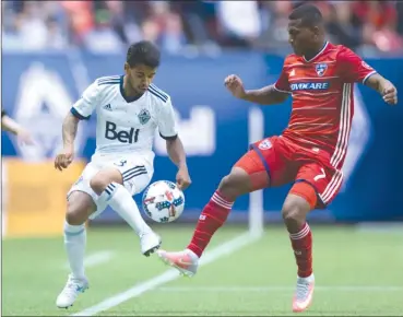  ?? The Canadian Press ?? Vancouver Whitecaps midfielder Cristian Techera, left, and FC Dallas’ Carlos Gruezo vie for the ball during the second half oftheirMLS­gameinVanc­ouveronSat­urdaynight.Theteamsti­ed1-1.