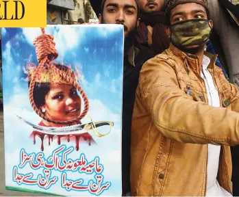  ?? ARIF ALI / AFP / GETTY IMAGES ?? Pakistani Islamists hold a poster displaying the portrait of Asia Bibi, a Christian Pakistani woman accused of blasphemy, during a protest in Lahore on Friday against the Supreme Court decision on Bibi’s case.