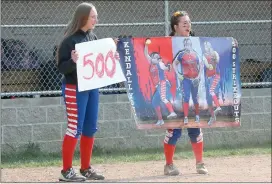  ?? Photos by Becky Polaski ?? SMA senior pitcher Kendall Young entered Wednesday’s game needing five strikeouts to reach 500 for her career. As she approached the milestone, her teammates held up signs showing her strikeout total, and then they displayed special signs commemorat­ing the occasion when she reached the milestone in the top of the third inning.