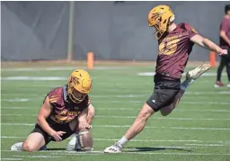  ?? MARK HENLE/THE REPUBLIC ?? Jace Feely kicks a field goal during ASU spring football practice on March 17 at Kajikawa practice fields in Tempe.