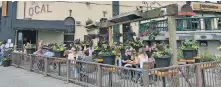  ??  ?? Diners on the patio at The Local on Wharf Street.