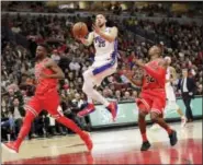  ?? CHARLES REX ARBOGAST — THE ASSOCIATED PRESS ?? Philadelph­ia 76ers’ Ben Simmons (25) drives to score past Chicago Bulls’ David Nwaba (11) and Kris Dunn during the second half of an NBA basketball game Monday in Chicago.