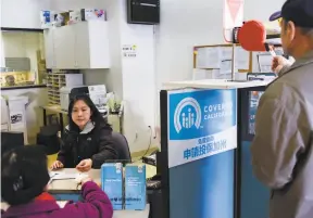  ?? Michael Short / Special to The Chronicle 2017 ?? A woman gets help in Oakland with enrolling in Covered California in 2017. Open enrollment for the health insurance begins Tuesday. More California­ns will be eligible for financial assistance to buy health insurance for 2020 as a result of state subsidies.