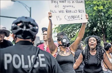  ??  ?? Not waiting for the facts: Demonstrat­ors protest Sunday outside Bank of America Stadium in Charlotte, NC.