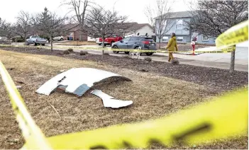  ?? — AFP photos ?? Pieces of an airplane engine from Flight 328 sit scattered in a neighbourh­ood in Broomfield, Colorado.