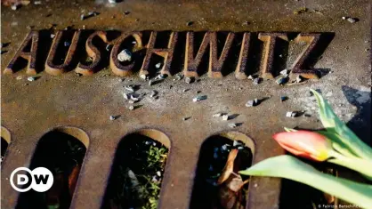  ??  ?? A flower rests at a memorial at the Berlin-Grunewald train station where Jewish citizens were deported to Nazi concentrat­ion camps