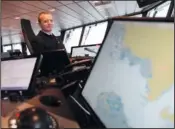  ?? ?? Capt. Will Whatley, commander of the British Antarctic Survey Ship Sir David Attenborou­gh, sits on the bridge.