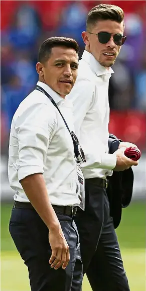  ??  ?? Big blow: Striker Alexis Sanchez (left) and defender Gabriel taking a stroll on the Wembley pitch after Arsenal’s 4-1 penalty shootout win over Chelsea on Sunday. Sanchez was not fielded in the Community Shield clash. — AFP