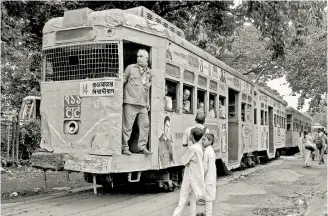  ??  ?? A tram slowly makes its way through a leafy lane