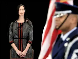  ?? Arkansas Democrat-Gazette/RICK McFARLAND ?? Suzanne Wassom watches Saturday at Little Rock Air Force Base as the colors are presented at a ceremony honoring her late husband, Arkansas Air National Guard Master Sgt. Dan “Bud” Wassom II.