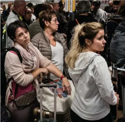  ??  ?? Zaventem, vrijdag: gestrande reizigers, wachtend op nieuws. Zo’n tweehonder­d vluchten werden geschrapt.