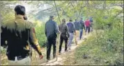  ?? ANI ?? Police officers during a search operation to find Walkar’s body parts in a forested area in Mehrauli, in Delhi last week.