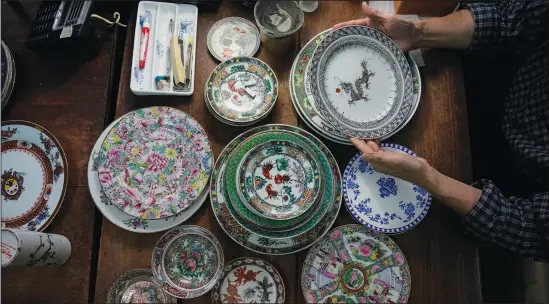  ?? (AP/Kin Cheung) ?? Joseph Tso, owner of Yuet Tung China Works, Hong Kong’s last hand-painted porcelain factory, holds a plate with dragon print June 8 in Hong Kong.