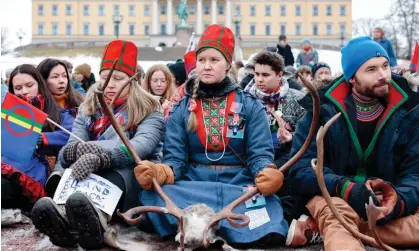  ?? Photograph: Alf Simensen/NTB/AFP/Getty Images ?? Members of the Sámi community protesting against the building of wind turbines on land traditiona­lly used to herd reindeer in Oslo, Norway, in March.