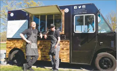  ?? STAFF PHOTO BY DARWIN WEIGEL ?? Jeremy Plemons, left, of Indian Head and Damian Tarlecki of D.C., who grew up in La Plata, revved up their County Manners food truck in late March and have been serving up smoked barbecue in Indian Head and at the La Plata Farmer’s Market.