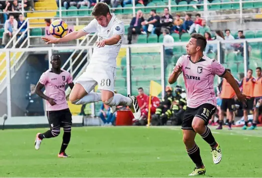  ??  ?? High order: AC Milan’s Mario Pasalic rising to head the ball in the Serie A match against Palermo on Nov 6. — AFP