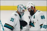  ?? MARK J. TERRILL – THE ASSOCIATED PRESS ?? San Jose Sharks goaltender Martin Jones, left, is congratula­ted by defenseman Brent Burns after the Sharks defeated the Los Angeles Kings 3-0 on Friday.