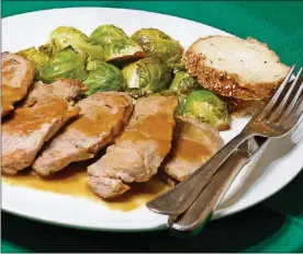  ?? LINDA ?? Whiskey mustard-crusted pork with balsamic glazed Brussels sprouts. GASSENHEIM­ER / TNS