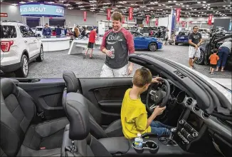  ?? RICARDO B. BRAZZIELL / AMERICAN-STATESMAN 2017 ?? Brett Dahl smiles as he watches his son, Phillip, 10, play behind the wheel of a Ford Mustang convertibl­e at the 2017 Austin Auto show at the Austin Convention Center in March. Aside from the Mustang, Ford likes to name its cars starting with the...