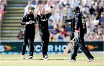  ?? GETTY IMAGES ?? Colin Munro of New Zealand celebrates with team-mates after taking the wicket of Joe Root of England during game one in the ODI series at Seddon Park.