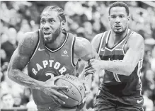  ?? ROB CARR GETTY IMAGES ?? Trevor Ariza, right, of the Wizards fouls Kawhi Leonard of the Raptors in double overtime at Capital One Arena in Washington on Sunday.