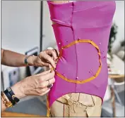  ?? AN RONG XU/THE NEW YORK TIMES ?? Araks Yeramyan, the creative director of a namesake line of swimwear, lingerie and loungewear, works on a new swimsuit design at her studio in New York on June 2.