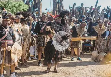  ?? RAJESH JANTILAL/GETTY-AFP ?? The new king of South Africa’s Zulu nation, Misuzulu kaZwelithi­ni, center, looks on during his coronation Saturday at the Zulu royal palace at Kwa-Nongoma, some 190 miles north of Durban. As head of the Zulu nation that controls over 10,810 square miles in KwaZulu-Natal province, the king is arguably the nation’s most influentia­l traditiona­l leader.