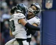  ?? MATT DUNHAM — THE ASSOCIATED PRESS ?? Philadelph­ia Eagles tight end Dallas Goedert (88), left, celebrates after scoring a touchdown during the first half of an NFL football game against Jacksonvil­le Jaguars at Wembley stadium in London, Sunday.