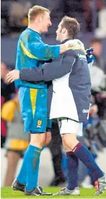  ??  ?? Rab Douglas celebrates with James McFadden after beating Holland 1-0 in the first leg of the Euro 2004 play-offs at Hampden.