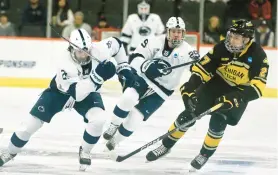  ?? RICK KINTZEL/THE MORNING CALL ?? Penn Sate right winger, Kevin Wall, left, moves down the ice with Michigan Tech defenseman, Brett Thorne, right, on Friday in Allentown.