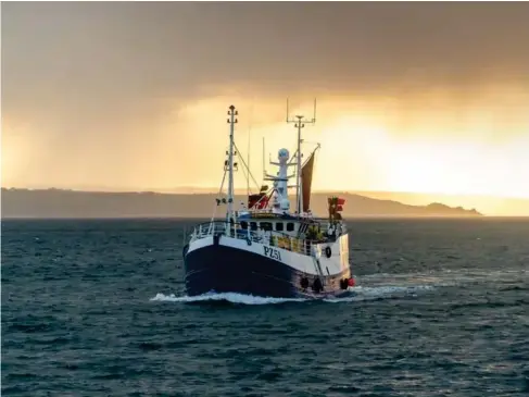  ?? (Getty) ?? New l yn gi ll- netter returns to port in Cornwa ll