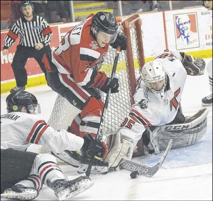  ?? TRURO NEWS PHOTO ?? Truro netminder Alec Macdonald looks to corral the puck as Dylan Riley of the Pictou County Weeks Crushers puts the pressure on. Macdonald stopped 29 of 30 shots and assisted on Shaun Bily’s overtime winner as the Bearcats defeated the Crushers 2-1. Macdonald is among five Truro players chosen for the south division squad that will play at the upcoming eighth annual Eastern Canada Cup All-star Challenge.