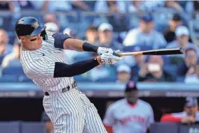  ?? AP ?? Yankees outfielder Aaron Judge hits a double in the ninth inning of an Opening Day game against the Red Sox on Friday in New York.