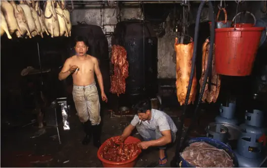  ??  ?? Clockwise from above: Barbecued Meat Factory (1989); Kowloon Walled City, from South East Corner (vertical) (1987); Dental Assistant (1990), all by Greg Girard