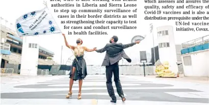  ??  ?? DANCERS wave a giant ‘All for Vaccines’ flag in São Paulo’s Sambadrome, Brazil.