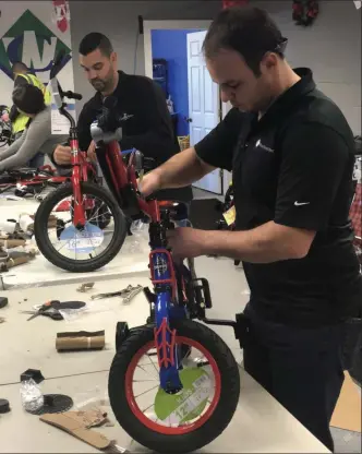  ?? COUNTY WASTE PHOTO ?? For the seventh consecutiv­e year, County Waste employees gathered to assemble and deliver 300 bikes to youth organizati­ons across the Capital Region.