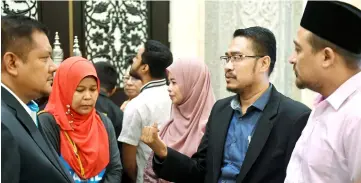  ??  ?? Mohd Fakhrulraz­i’s (second right) eight-month jail changed to RM1,800 fine by the Court of Appeal. — Bernama photo