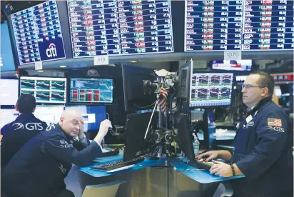  ?? (Lucas Jackson/Reuters) ?? TRADERS WORK on the floor of the New York Stock Exchange last Friday. Large-cap US tech companies rose 2.6% yesterday, but they are still down more than 7% from a record high hit four weeks ago.