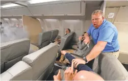  ??  ?? 1. Trainers simulate a terror assault. “Attackers” on a mock plane in Egg Harbor Township, N.J., with actors as passengers, threaten to set off a bomb.