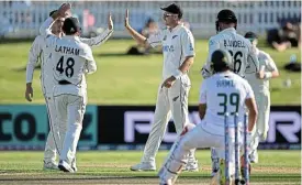  ?? Joe Allison/Getty Images ?? Tough luck: New Zealand players celebrate while Zubayr Hamza curses his misfortune after a ball from Mitchell Santner deflected off the batter onto his stumps. /