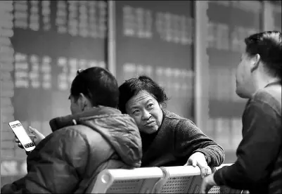  ??  ?? Investors discuss share price movements at a securities brokerage in Beijing. WANG JING / CHINA DAILY