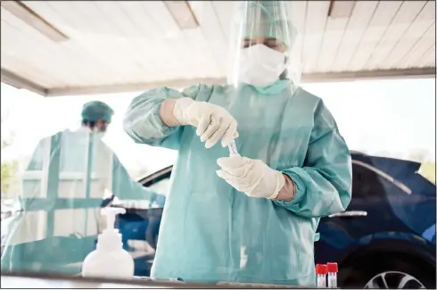  ??  ?? Doctors take sample swabs from patient in their cars, for a check some time after they were dismissed from the hospital of Cinisello Balsamo, on the outskirts of Milan,
April 8. (AP)