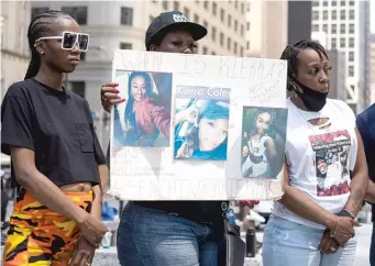  ?? SUN-TIMES FILES ?? ABOVE: Karen Phillips (right) is joined last July by family members at a press conference in Daley Plaza seeking answers about the disappeara­nce of her daughter, postal worker Kierra Coles.