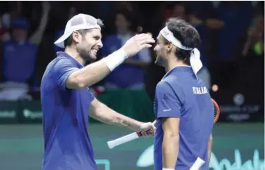  ?? Agence France-presse ?? Italy’s Simone Bolelli (left) and Fabio Fognini celebrate their victory over Tommy Paul and Jack Sock of the US after their double quarter-final match of the Davis Cup.