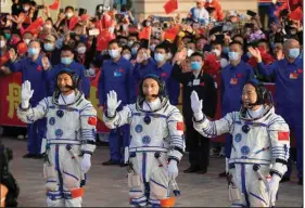  ?? (AP/Mark Schiefelbe­in) ?? Chinese astronauts Gui Haichao (from left), Zhu Yangzhu and Jing Haipeng attend a send-off ceremony Tuesday at the Jiuquan Satellite Launch Center in northweste­rn China.